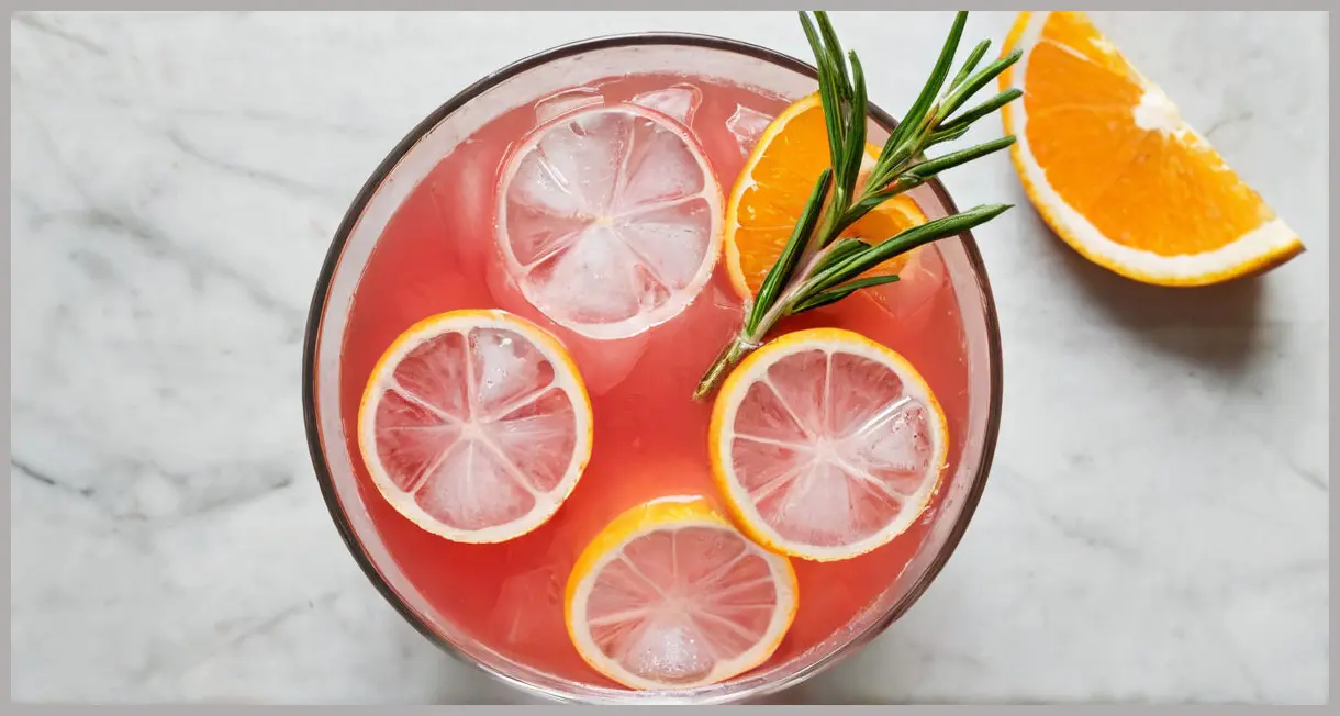 Photorealistic, bright Rhubarb and ginger cocktail Cocktail in a fancy tumbler, garnished with rosemary and a dehydrated orange wheel, viewed from a top-down perspective under natural daylight.