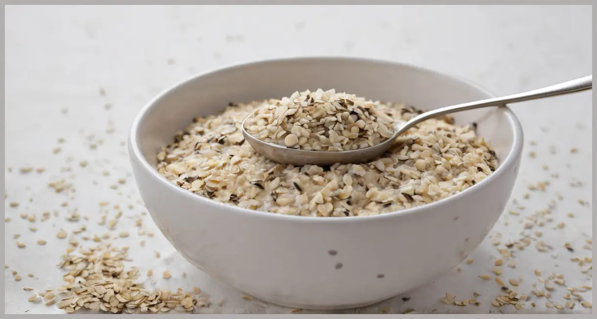 A macro shot of overnight oats topped with chia seeds and coconut flakes, captured in soft studio light with creamy textures. Easy overnight oats.