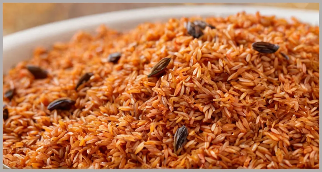 Smoky jollof rice grain in close-up, golden edges, smoked paprika flecks, thyme, soft studio light. Intimate and appetizing.