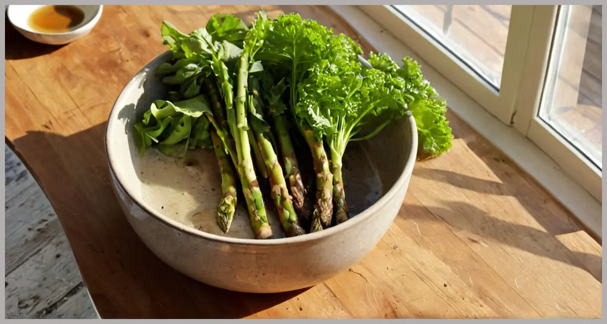 A top-down view of a ceramic bowl with warmed asparagus and lettuce, steam rising, mint garnish, on a sunlit wooden table. Warmed asparagus and lettuce
