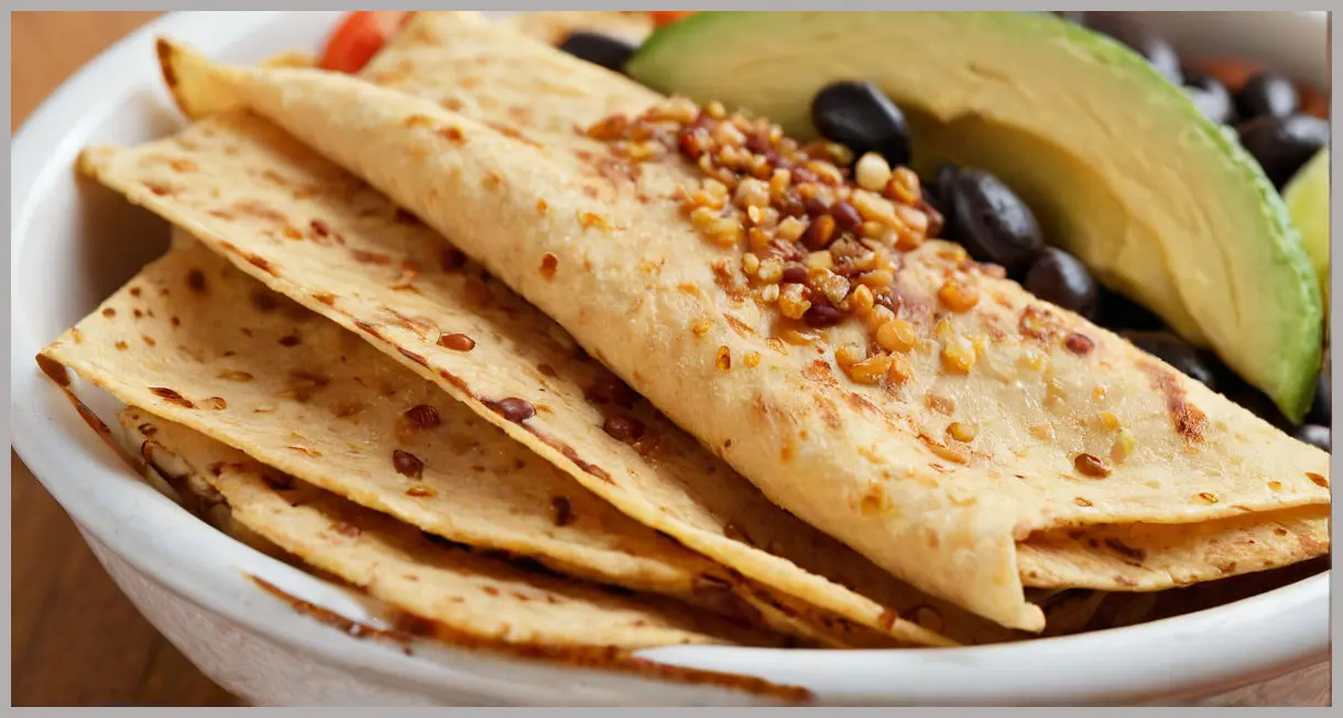Close-up of a golden crispy tortilla strip from a Crispy Mexican tortilla rice bowl, ultra-detailed texture in soft studio light.